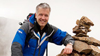 Derek on the summit. Image © Glyn Davies photography