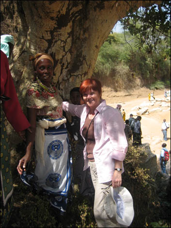 Alison and the village ladies leaning on a baobab tree.  
