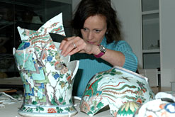 Penny Bendall fixing one of the Chinese vases