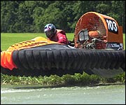A hovercraft glides over water in an exciting race