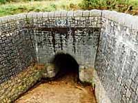 The 20 foot drop down into the intake basin presented no difficulty to the men. Note that the tunnel has been run dry for the occasion.
