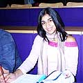 Arunima writing during a lecture