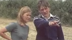 John a Mareged yn sefyll mewn cae