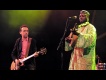 Justin Adams with Juldeh Camara live at the Old Fruitmarket. Photo by Louis Decarlo