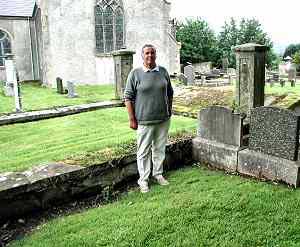 Sam Moore stands at family burial spot