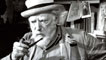 Augustus John smoking a pipe at his home