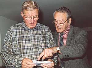 Ex tunnel engineers Norman Ervine and Harold McCaughan look through photographs of their work from 50 years ago