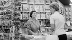 A lady trying to 'buy a guide book'