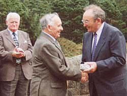 Sandy receiving his commorative plaque from the CEO of the NI Water Service on the occasion of the 50th anniversary reunion.