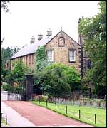 Farm buildings and St James Church (obscured by trees)