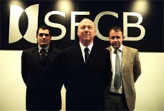 Scene from BBC2's The Man Who Broke Britain - SFCB senior trader Samir Badr played by Mansour Abou Chahine, SFCB Chief Exec. played by Mark Hyde, and senior trader Philip Crighton (Will Ashcroft)