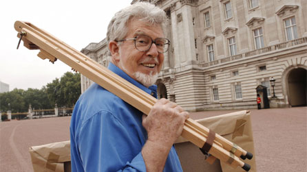 Rolf Harris outside Buckingham Palace  while filming The Queen By Rolf