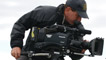 Rob McDougal filming from a wall