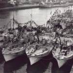 This picture was taken by me from the top of the water tower at Great Yarmouth.    it shows the 63rd Motor Torpedo Boat flotilla dressed to celebrate VE Day.   MTB 753 is the boat tied up alongside the jetty, with some of my shipmates on the fo'c'sle.