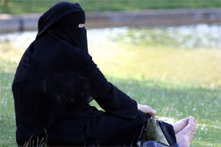 Image: A Muslim woman, wearing a burqa