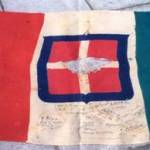 The Italian flag captured in Libya  on November 21st 1942 by a detachment of the 8th Army and signed by them. George Cosmo McCallam won the lot to keep the flag.
