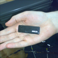 A small GPS receiver device, about the ssize of a packet of chewing gum, sits in the middle of Damon's palm