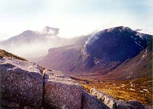 Looking southwards down the Annalong Valley from the Mourne Wall on Slieve Donard. The distinctive 'Dinosaur's Back' profile of Slieve Binnian is visible in the distance shrouded in mist