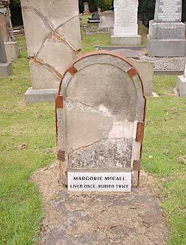 Cracked Headstone bound with rusted Iron