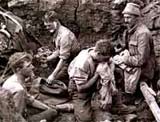 Image of British soldiers washing and shaving in a hole made by a heavy shell on Mount Kemmel, September 1918