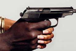a man and woman's hand holding a gun