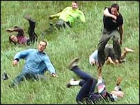 Men chasing cheese