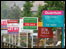 Street with For Sale signs.